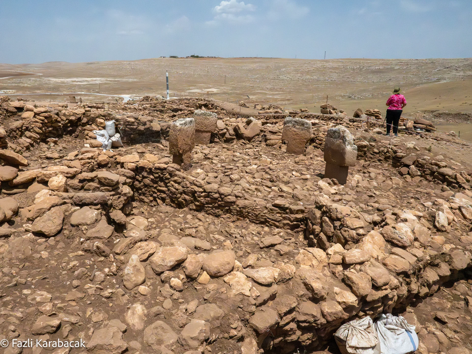 Visitors walking on the elevated walkway above the Karahantepe excavation site