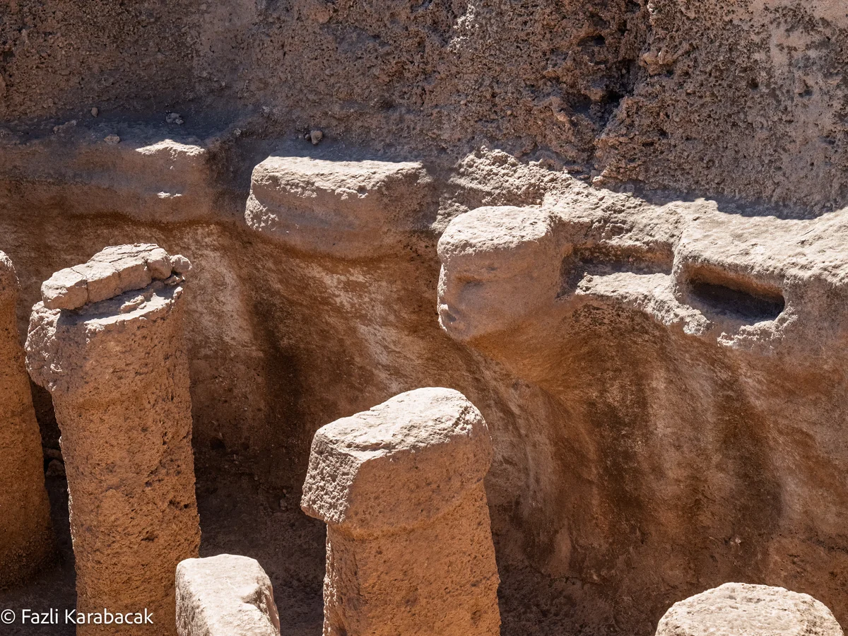 The central human figure emerging from bedrock in Structure AB